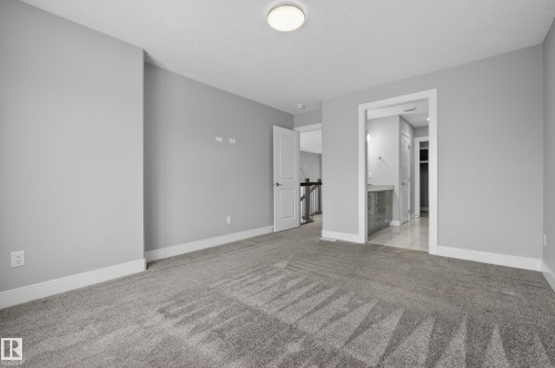 Unfurnished bedroom with light colored carpet and ensuite bath - 3224 160 Street, Edmonton, AB - Indoor Photo Showing Other Room