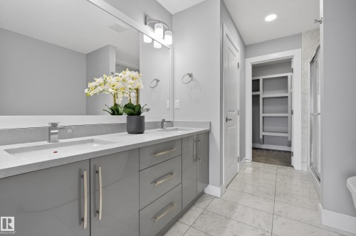 Bathroom with double vanity, a shower stall, a walk in closet, light marble finish flooring, and recessed lighting - 3224 160 Street, Edmonton, AB - Indoor Photo Showing Bathroom