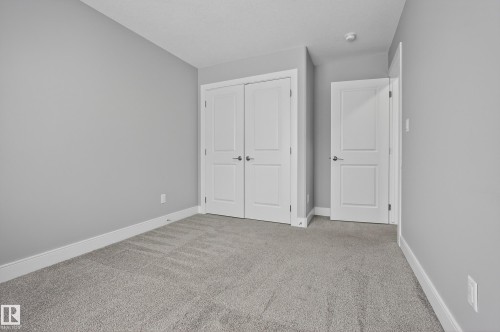 Unfurnished bedroom featuring carpet and a closet - 3224 160 Street, Edmonton, AB - Indoor Photo Showing Other Room