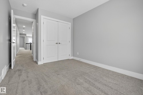 Unfurnished bedroom featuring light carpet and a closet - 3224 160 Street, Edmonton, AB - Indoor Photo Showing Other Room