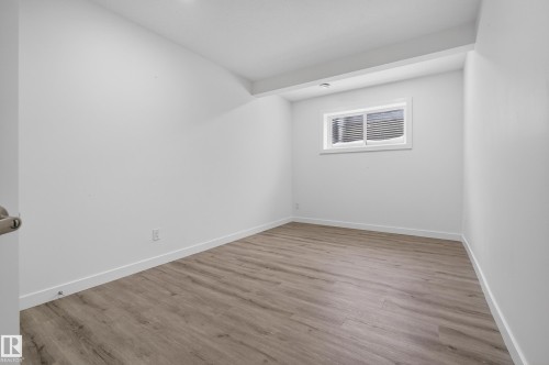 Empty room with light wood-style flooring and baseboards - 3224 160 Street, Edmonton, AB - Indoor Photo Showing Other Room