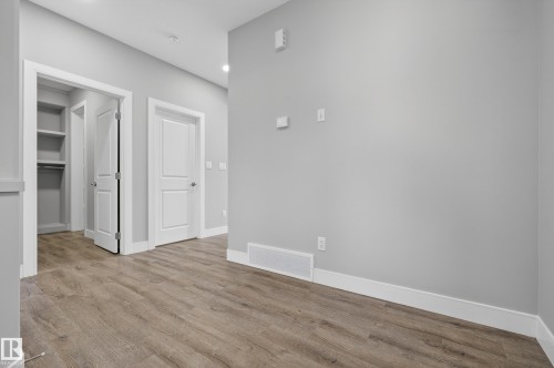 Unfurnished bedroom with a spacious closet and light wood-style floors - 3224 160 Street, Edmonton, AB - Indoor Photo Showing Other Room