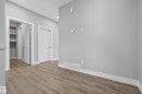 Unfurnished bedroom with a spacious closet and light wood-style floors - 3224 160 Street, Edmonton, AB  - Indoor Photo Showing Other Room 