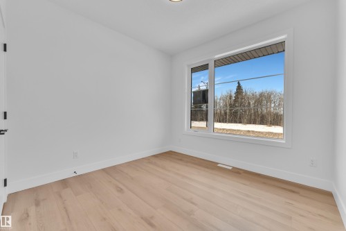 Empty room featuring baseboards and light wood-type flooring - 6111 Crawford Drive, Edmonton, AB - Indoor Photo Showing Other Room