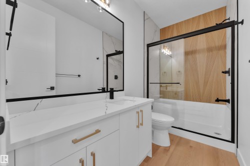 Bathroom featuring vanity, a marble finish shower, and light wood finished floors - 6111 Crawford Drive, Edmonton, AB - Indoor Photo Showing Bathroom