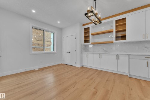 Kitchen featuring white cabinetry, open shelves, glass insert cabinets, and light wood-style floors - 6111 Crawford Drive, Edmonton, AB - Indoor
