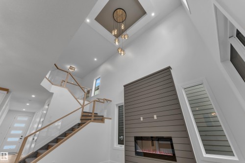 Detailed view of recessed lighting and a glass covered fireplace - 6111 Crawford Drive, Edmonton, AB - Indoor Photo Showing Other Room With Fireplace