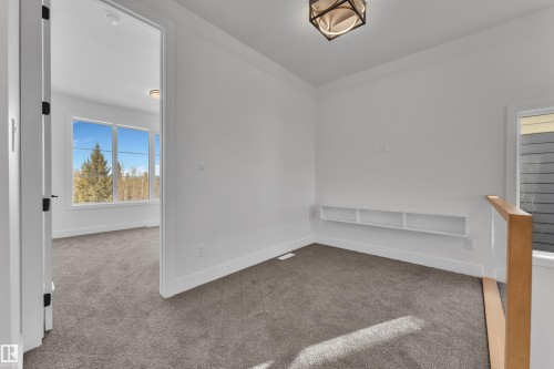 Carpeted spare room featuring baseboards - 6111 Crawford Drive, Edmonton, AB - Indoor Photo Showing Other Room