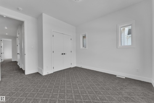 Carpeted spare room featuring baseboards - 6111 Crawford Drive, Edmonton, AB - Indoor Photo Showing Other Room