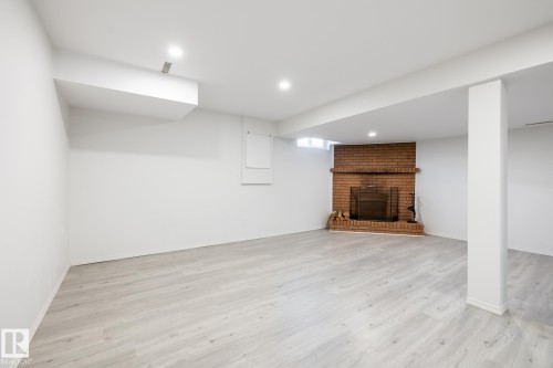 Finished basement with a fireplace, light wood-style floors, and recessed lighting - 13449 40 Street, Edmonton, AB - Indoor