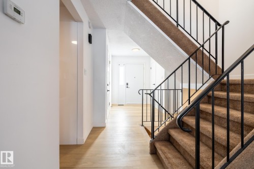 Staircase with wood finished floors and baseboards - 13449 40 Street, Edmonton, AB - Indoor Photo Showing Other Room