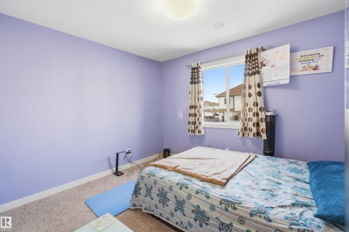 Carpeted bedroom featuring baseboards - 2923 16 Street, Edmonton, AB - Indoor Photo Showing Bedroom