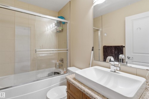 Bathroom featuring vanity and enclosed tub / shower combo - 2923 16 Street, Edmonton, AB - Indoor Photo Showing Bathroom