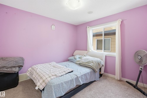 Bedroom with baseboards and light colored carpet - 2923 16 Street, Edmonton, AB - Indoor Photo Showing Bedroom