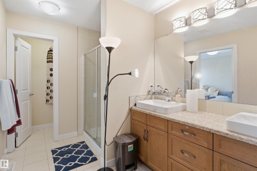 Bathroom with a stall shower, double vanity, and light tile patterned floors - 2923 16 Street, Edmonton, AB - Indoor Photo Showing Bathroom