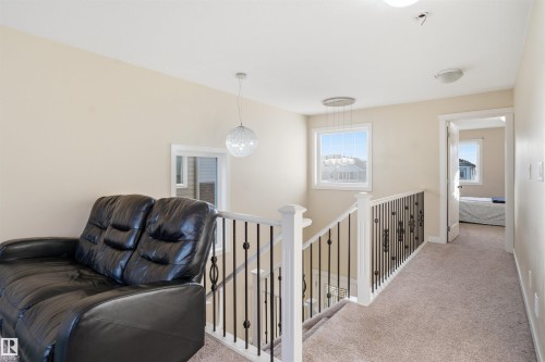 Sitting room featuring an upstairs landing, carpet floors, and a chandelier - 2923 16 Street, Edmonton, AB - Indoor Photo Showing Other Room