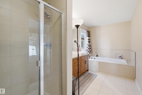 Full bath featuring a shower stall, vanity, a garden tub, and light tile patterned flooring - 2923 16 Street, Edmonton, AB - Indoor Photo Showing Bathroom