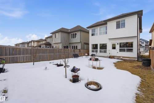 Snow covered back of property featuring a fenced backyard and a residential view - 2923 16 Street, Edmonton, AB - Outdoor