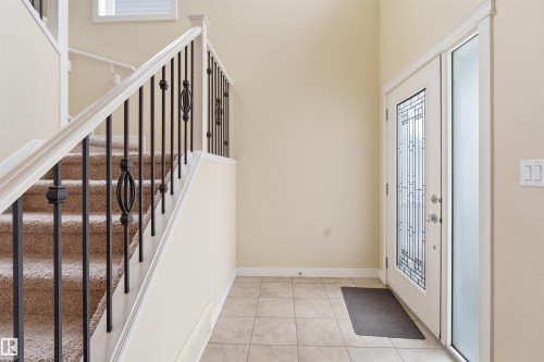 Entryway with light tile patterned floors and stairs - 2923 16 Street, Edmonton, AB - Indoor Photo Showing Other Room