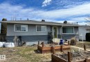 The property features a gray exterior with contrasting dark gray siding and a light gray roof - 15003 81 Street, Edmonton, AB  - Outdoor 