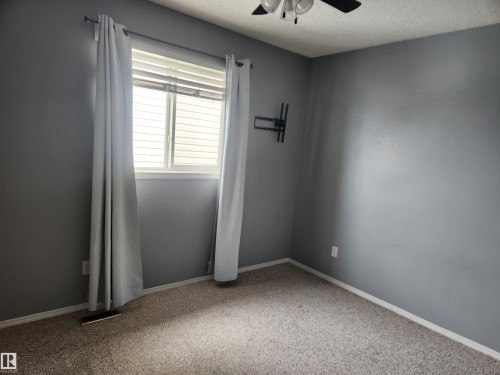 Spare room with ceiling fan, a textured ceiling, and light colored carpet - 14076 152 Avenue, Edmonton, AB - Indoor Photo Showing Other Room
