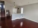 Unfurnished living room with dark wood-style floors and stairs - 14076 152 Avenue, Edmonton, AB  - Indoor Photo Showing Other Room 