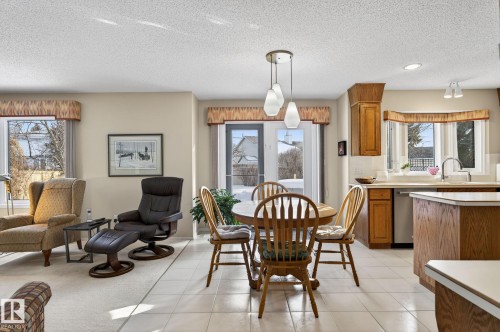 Dining space with a textured ceiling and light tile patterned flooring - 313 Hedley Way, Edmonton, AB - Indoor