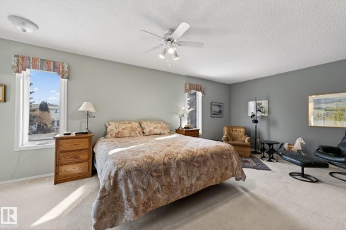 Bedroom with multiple windows, carpet, a textured ceiling, and a ceiling fan - 313 Hedley Way, Edmonton, AB - Indoor Photo Showing Bedroom