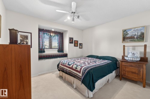 Bedroom with carpet floors, a ceiling fan, and a textured ceiling - 313 Hedley Way, Edmonton, AB - Indoor Photo Showing Bedroom
