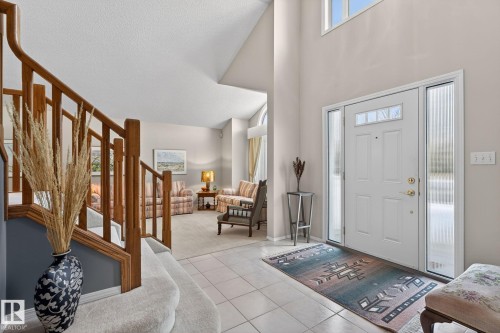 Entryway with light tile patterned flooring, a high ceiling, and light carpet - 313 Hedley Way, Edmonton, AB - Indoor Photo Showing Other Room