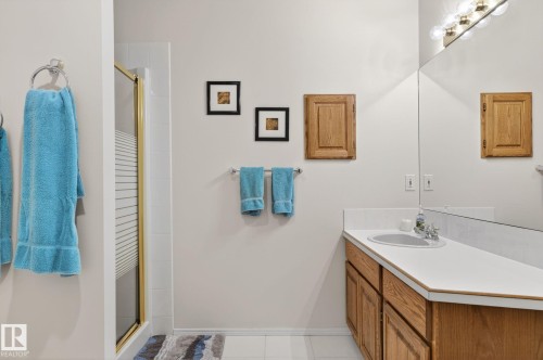 Full bathroom featuring a stall shower, vanity, and light tile patterned flooring - 313 Hedley Way, Edmonton, AB - Indoor Photo Showing Bathroom