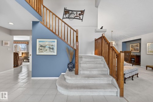Staircase with tile patterned flooring, a high ceiling, and recessed lighting - 313 Hedley Way, Edmonton, AB - Indoor Photo Showing Other Room