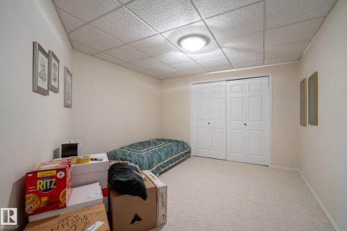 Bedroom with light colored carpet, a paneled ceiling, and a closet - 313 Hedley Way, Edmonton, AB - Indoor