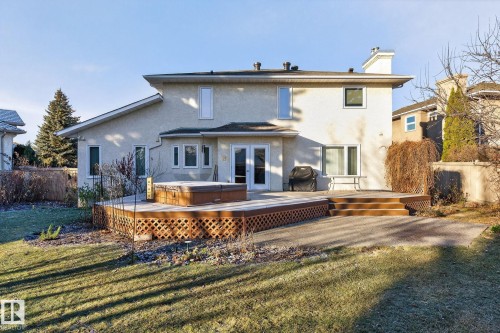Rear view of house featuring a hot tub, stucco siding, french doors, a deck, and a chimney - 313 Hedley Way, Edmonton, AB - Outdoor With Deck Patio Veranda