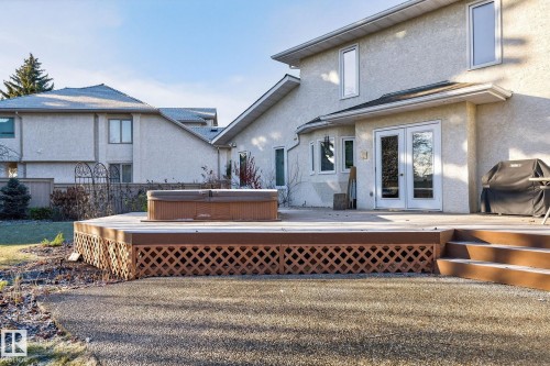 Back of house featuring french doors, a hot tub, stucco siding, and a deck - 313 Hedley Way, Edmonton, AB - Outdoor With Deck Patio Veranda