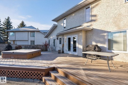 Deck with a covered hot tub, area for grilling, and french doors - 313 Hedley Way, Edmonton, AB - Outdoor With Deck Patio Veranda