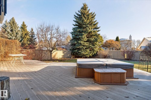 Wooden deck with a fenced backyard and a hot tub - 313 Hedley Way, Edmonton, AB - Outdoor With Deck Patio Veranda