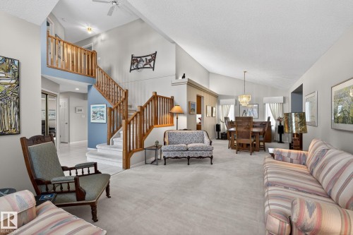 Carpeted living room with a high textured ceiling, suspended lighting, and a ceiling fan - 313 Hedley Way, Edmonton, AB - Indoor Photo Showing Living Room