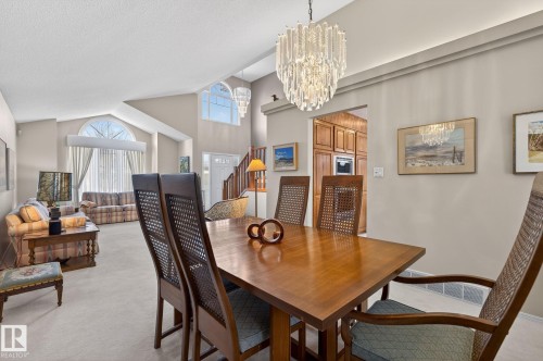 Dining room with light carpet, suspended lighting, and vaulted ceiling - 313 Hedley Way, Edmonton, AB - Indoor Photo Showing Dining Room