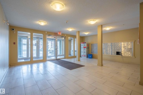 Community lobby featuring a textured ceiling - 415 111 Watt Common, Edmonton, AB - Indoor Photo Showing Other Room