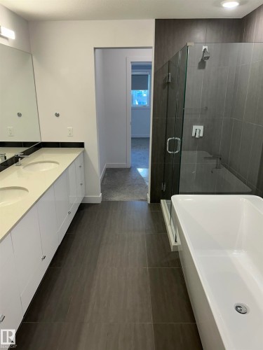 Full bathroom with a soaking tub, double vanity, and a shower stall - 202 8510 90 Street, Edmonton, AB - Indoor Photo Showing Bathroom