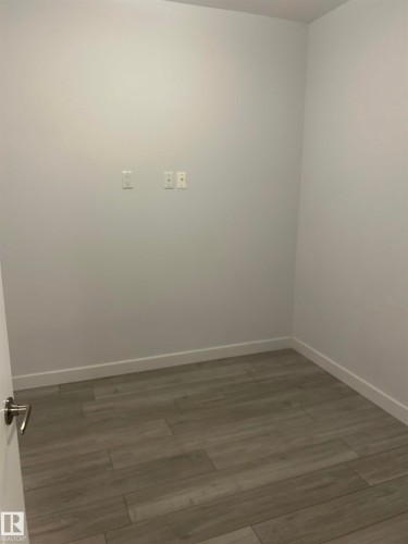 Empty room featuring wood finished floors - 202 8510 90 Street, Edmonton, AB - Indoor Photo Showing Other Room