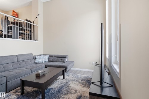 Living area featuring wood finished floors and baseboards - 48 1140 Chappelle Boulevard, Edmonton, AB - Indoor