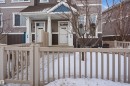 Snow covered property entrance with a porch and a shingled roof - 48 1140 Chappelle Boulevard, Edmonton, AB  - Outdoor 