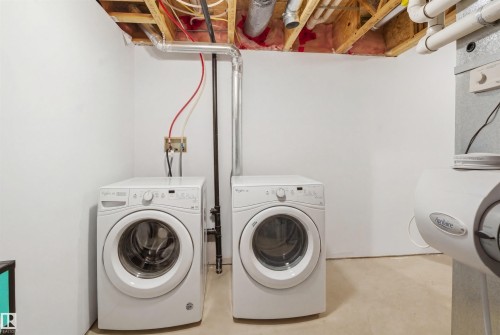 Laundry area featuring concrete flooring and washer and clothes dryer - 48 1140 Chappelle Boulevard, Edmonton, AB - Indoor Photo Showing Laundry Room