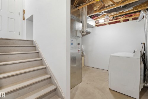 Stairs featuring washer / clothes dryer and concrete floors - 48 1140 Chappelle Boulevard, Edmonton, AB - Indoor