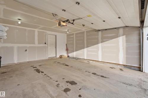 Garage with a garage door opener - 48 1140 Chappelle Boulevard, Edmonton, AB - Indoor Photo Showing Garage