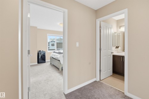 Corridor featuring light colored carpet and baseboards - 48 1140 Chappelle Boulevard, Edmonton, AB - Indoor