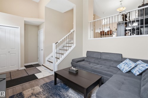 Living area with stairway and wood finished floors - 48 1140 Chappelle Boulevard, Edmonton, AB - Indoor