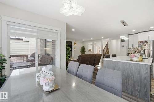 Dining space featuring stairs, dark wood-style floors, and recessed lighting - 1532 37C Avenue, Edmonton, AB - Indoor Photo Showing Dining Room